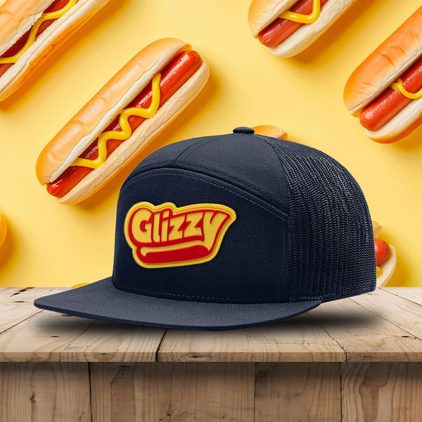 Navy hat with a rubber patch that reads Glizzy on a wood table 